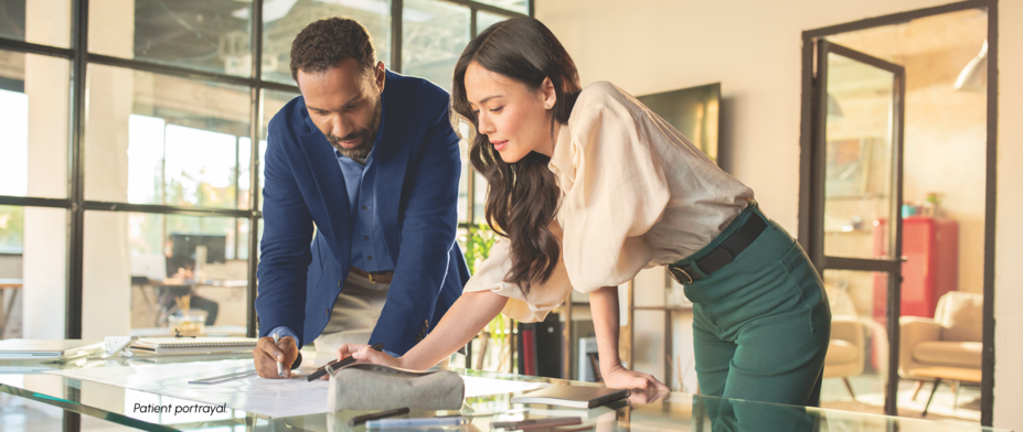 Man and woman working on blueprints together